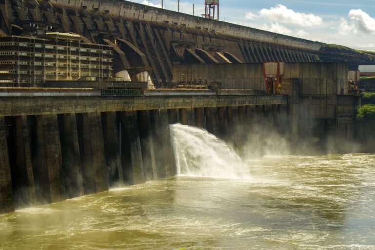 Scenic view of Itaipu Dam releasing water into the Paraná River, highlighting engineering marvel.