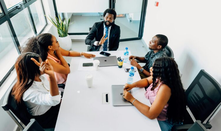 Business professionals engage in a collaborative meeting in a bright Lagos office.