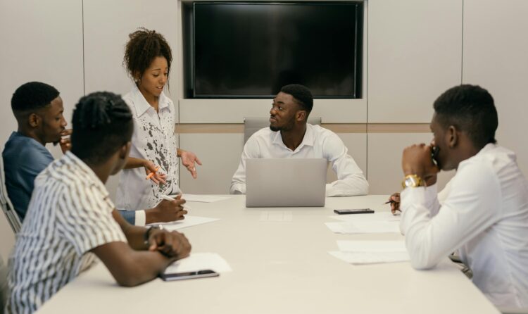 A diverse team of professionals collaborating in a modern office meeting environment.